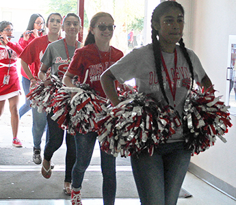 Group of cheerleaders walking into school