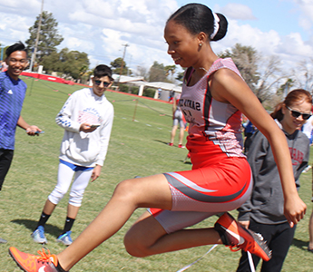 Janeya jumping during a track meet