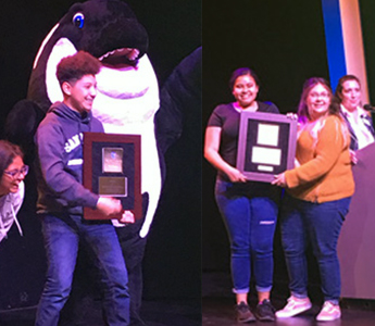 Students receiving awards on stage