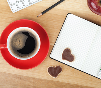 Coffee in a red mug on a desk