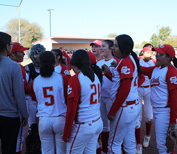 Girls baseball team in a huddle