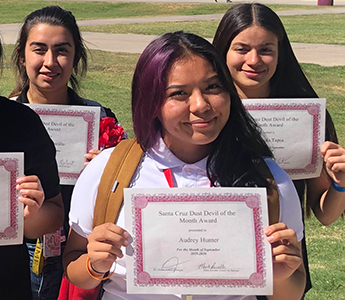 Proud student holding her award certificate